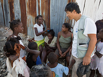Seung Don Kim visits with residents of Cit Soleil.