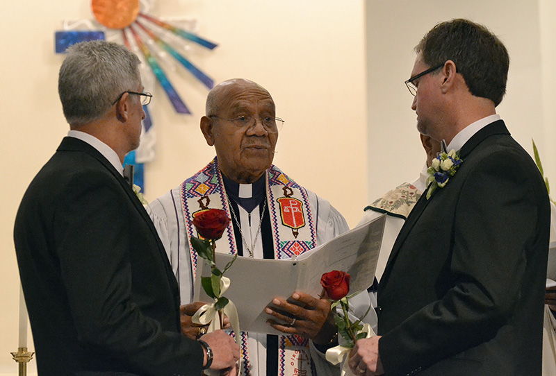 United Methodist Bishop Melvin Talbert (center) marries Joe Openshaw (left) and Bobby Prince at Covenant Community United Church of Christ in Center Point, Ala. Photo by the Rev. Laura Rossbert, Reconciling Ministries Network.