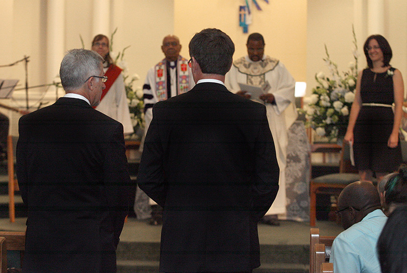 Joe Openshaw (left) and Bobby Prince approach the altar to be married by United Methodist Bishop Melvin Talbert (second from left in background) at Covenant Community United Church of Christ in Center Point, Ala. A UMNS photo by Kathy L. Gilbert.