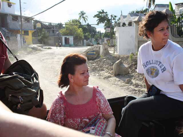 Jean Arnwine (center) rides in the back of a pickup truck during her first mission trip to Haiti.