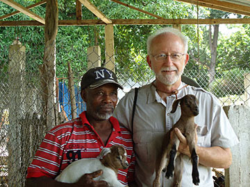 Farm assistant Lebon Augulus and the Rev. Jim Gulley hold young goat twins in Darbonne/Leogane, Haiti.  A UMNS web-only photo by Kamlesh Vyas, UMCOR-Haiti.