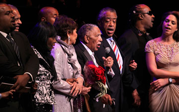 The Rev. Joseph E. Lowery (with microphone) leads the singing of We Shall Overcome during his 90th birthday celebration Oct. 9, 2011 at the Atlanta Symphony Hall. A UMNS photo by Kathleen Barry.