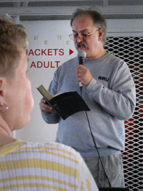 The Rev. Erik Alsgaard leads the Vesper worship by reading the creation story to the 221 passengers aboard the Arnold Ferry boat.
