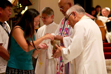 Western Jurisdiction bishops serve communion during July 18 worship. Photo by Patrick Scriven.