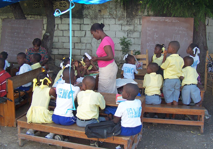 Children attend school under a tarp at the Carrefour Methodist church in Haiti. 