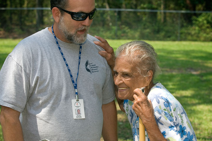 Leona Cousins shares a laugh outside her home with Ken Ward, contractor with the United Methodist Slidell (La.) Disaster Recovery Station in this 2006 photo.