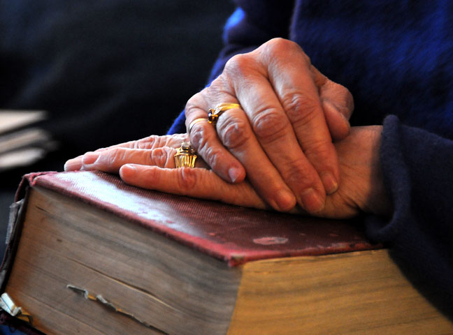 The Rev. Suzanne Field Rabb rests her hands on the family Bible.