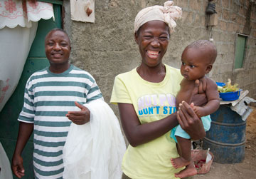 This Angolan family received a net as part of The United Methodist Church's Imagine No Malaria campaign. (From left) Domingos Adao, Esperances Manuel and baby Sandro dos Santos. A UMNS photo by Mike DuBose.