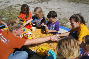 Children play in a corn box at the Harvest Celebration of Oxford United Methodist Church and First Christian Church of Lafayette, Ind. A web-only photo courtesy of Don Johnson.