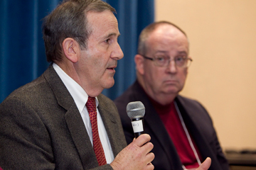 Economist Don House (left) helps lead a discussion about the church budget during the pre-General Conference news briefing at the Tampa Convention Center in Florida. At right is Bishop G. Lindsey Davis. A UMNS photo by Mike DuBose.