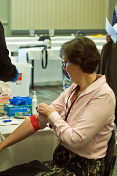 Denver Area Bishop Elaine Stanovsky rolls down her sleeve after being tested.