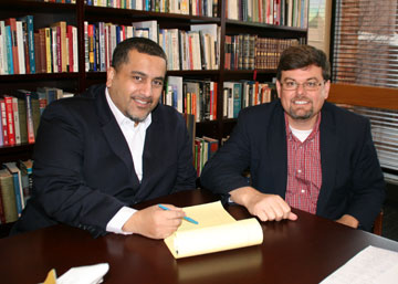 Peter Messiah, director of addiction prevention studies, and Mark Davies, dean of the Oklahoma City University Petree College of Arts and Sciences, review plans for the United Methodist school's undergraduate degree in addiction prevention studies.