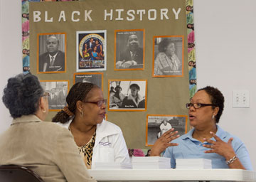 Valerie Murphy (right) and the Rev. Sheilah Easterling-Smith visit with Helen Harris (right) during a community health fair at Friendship United Methodist Church in Millington, Tenn., in November 2011. A UMNS file photo by Mike DuBose.