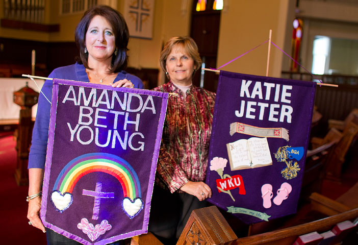 Beth Young (left) and Mamie Jeter hold banners honoring their daughters, Amanda and Katie. UMNS photos by Mike DuBose.