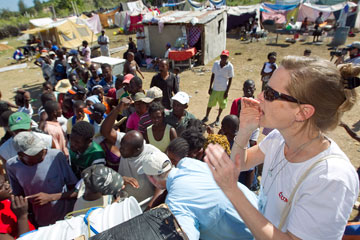 Melissa Crutchfield helps distribute water treatment supplies to people living in a makeshift camp in Gresier, Haiti, after the January 2010 earthquake.