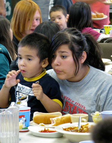 Children and their families enjoy a free meal at Wesley United Methodist Church in Fresno, Calif. Photo by Barry Simmons.