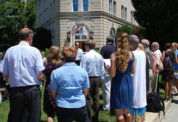 Jim Winkler reads during a prayer vigil for a faithful budget this past July in front of The United Methodist Building. A UMNS photo by Wayne Rhodes.