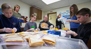 Youth from Medford and Epworth United Methodist churches in Elizabeth, N.J., pack lunches for area needy. A UMNS photo by Gwen Kisker.