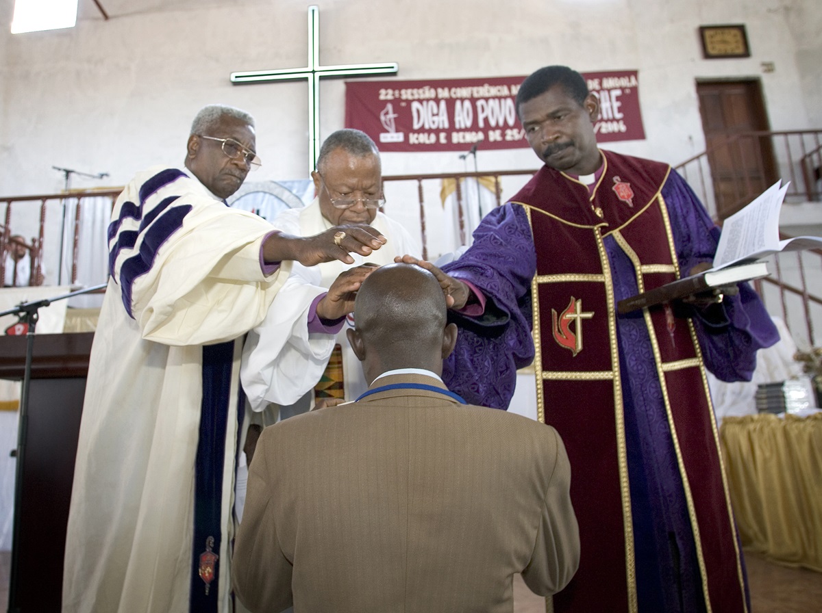 Bishops of the United Methodist Church in Angola lay hands on a new pastor during a 2006 ordination service at the West Angola Annual Conference session at the Icolo e Bengo United Methodist Church in Luanda. The United Methodist Church in Angola played a