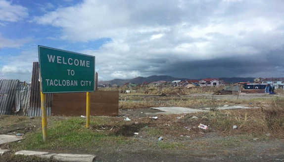 A sign that withstood the 195-mile-an-hour winds of Typhoon Yolanda stands outside Tacloban City in the Philippines.  Photo courtesy of April Grace Mercado.