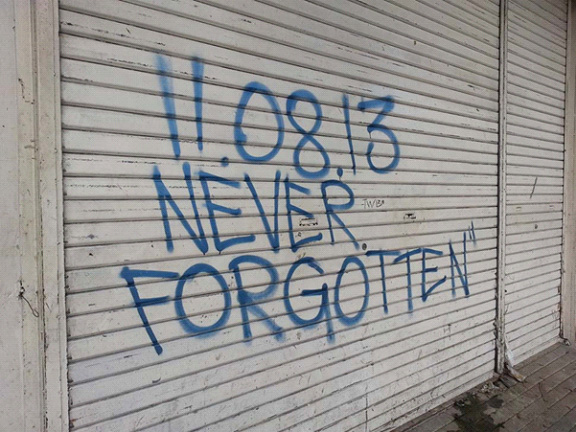 The United Methodist Communications team saw this graffiti written on the steel gate of a drugstore along Avenidas Veteranos in downtown Tacloban while recording GPS coordinates. Photo courtesy of April Grace Mercado.