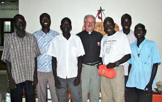 The Rev. Fred Dearing (center) stands with South Sudanese staff members of Grace Home for Children