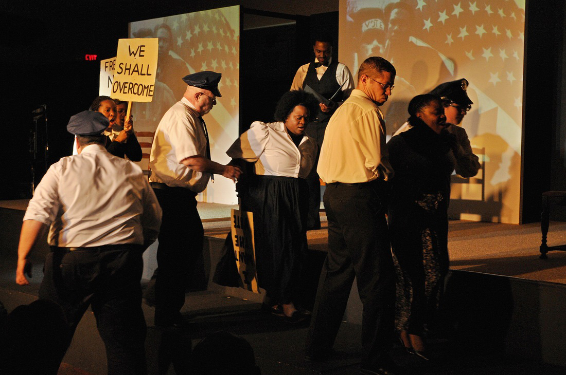 In this scene from “I Have a Dream” The Musical from TheatreSouth Atlanta, city official Bull Conner enforces segregation policies by arresting marchers during a 1963 civil rights demonstration in Birmingham, Ala. UMNS Photo by Yonnick Jones.