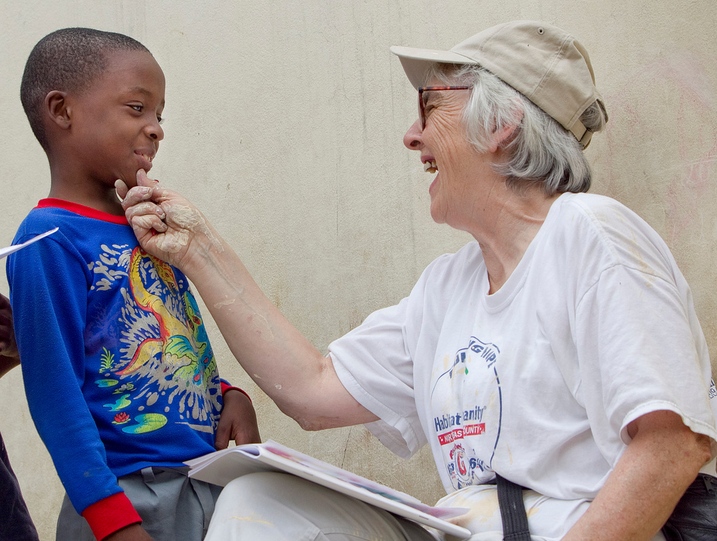 Her hands spattered with paint, United Methodist volunteer Kathy Ahmad takes a break from renovating the Methodist Children’s Home orphanage in Port-au-Prince, Haiti, to play a game with Franckenson Renevil. A UMNS photo by Mike DuBose.