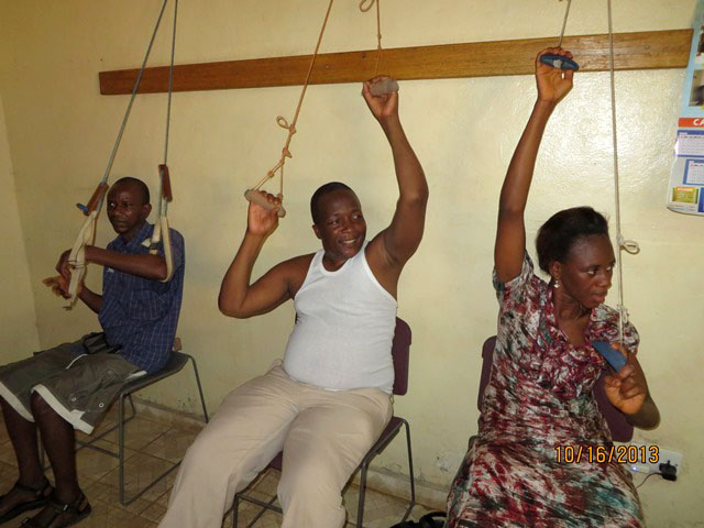 Dr Ibrahim Sallieu Kamara (center) and others work on limb exercise at the Physio-Therapy unit at the United Methodist General Hospital at Kissy in eastern Freetown, Sierra Leone. Photo by Phileas Jusu, UMNS.