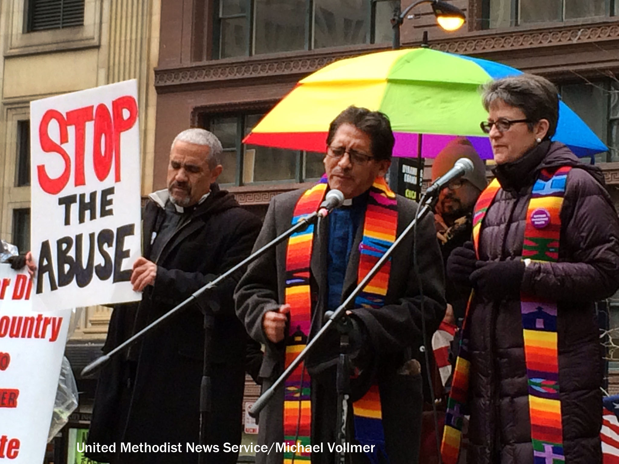 United Methodist clergy (from left) Jesus Molenia, Orlando Moller and Bishop Sally Dyck join other faith leaders in a rally and protest calling upon President Obama to stop deportations of undocumented people. Photo by Michael Vollmer, UMNS.