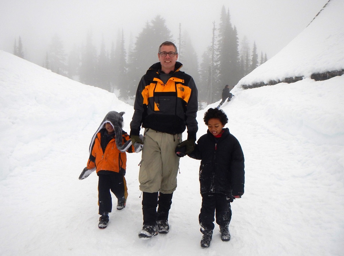 Scoutmaster Geoffrey McGrath walks with Davonn Abaga and Denzel Abaga, two members of the Cub Scout pack, during an outing to Mount Rainier National Park. Photo by Nguyen Truong, Cubmaster.