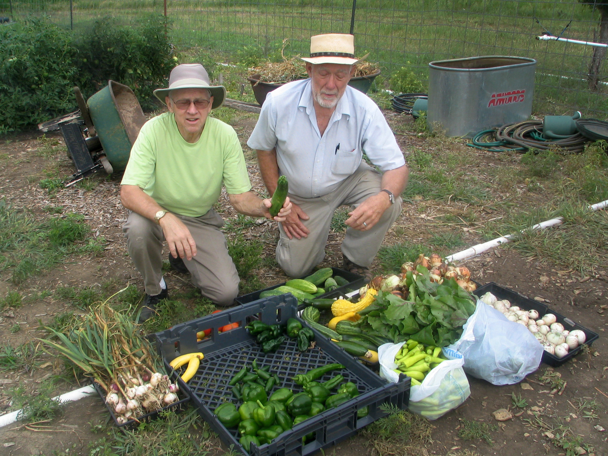 Two church volunteers, Dale Levy and Jay Sinnes, proudly display veggies from the Garden of Eatin’ at Bartlesville First Church. The garden began during Change the World weekend in 2009. Photo courtesy of Bartlesville First Church.