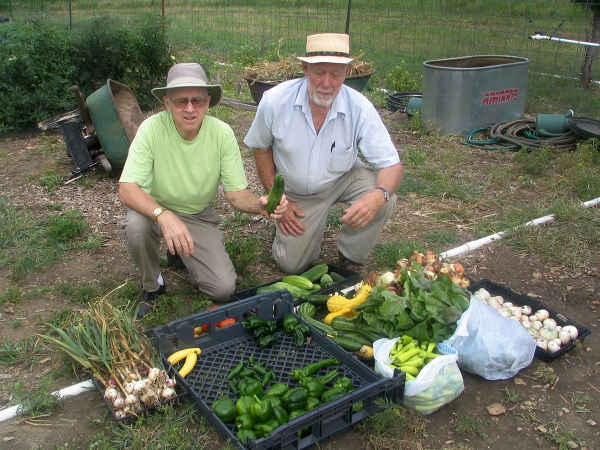 Two church volunteers, Dale Levy and Jay Sinnes, proudly display veggies from the Garden of Eatin’ at Bartlesville First Church. The garden began during Change the World weekend in 2009. Photo courtesy of Bartlesville First Church.