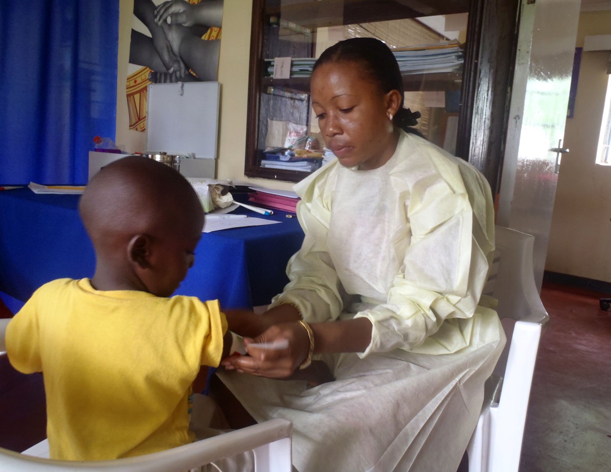 Mercy Nyirongo treats a child in a clinic in her home country of Malawi. A 2010 graduate of Africa University with a bachelor's degree in nursing, Nyirongo is project manager for the ZOE orphan-empowerment program of The United Methodist Church in Malawi.Photo Courtesy Mercy Nyironga.