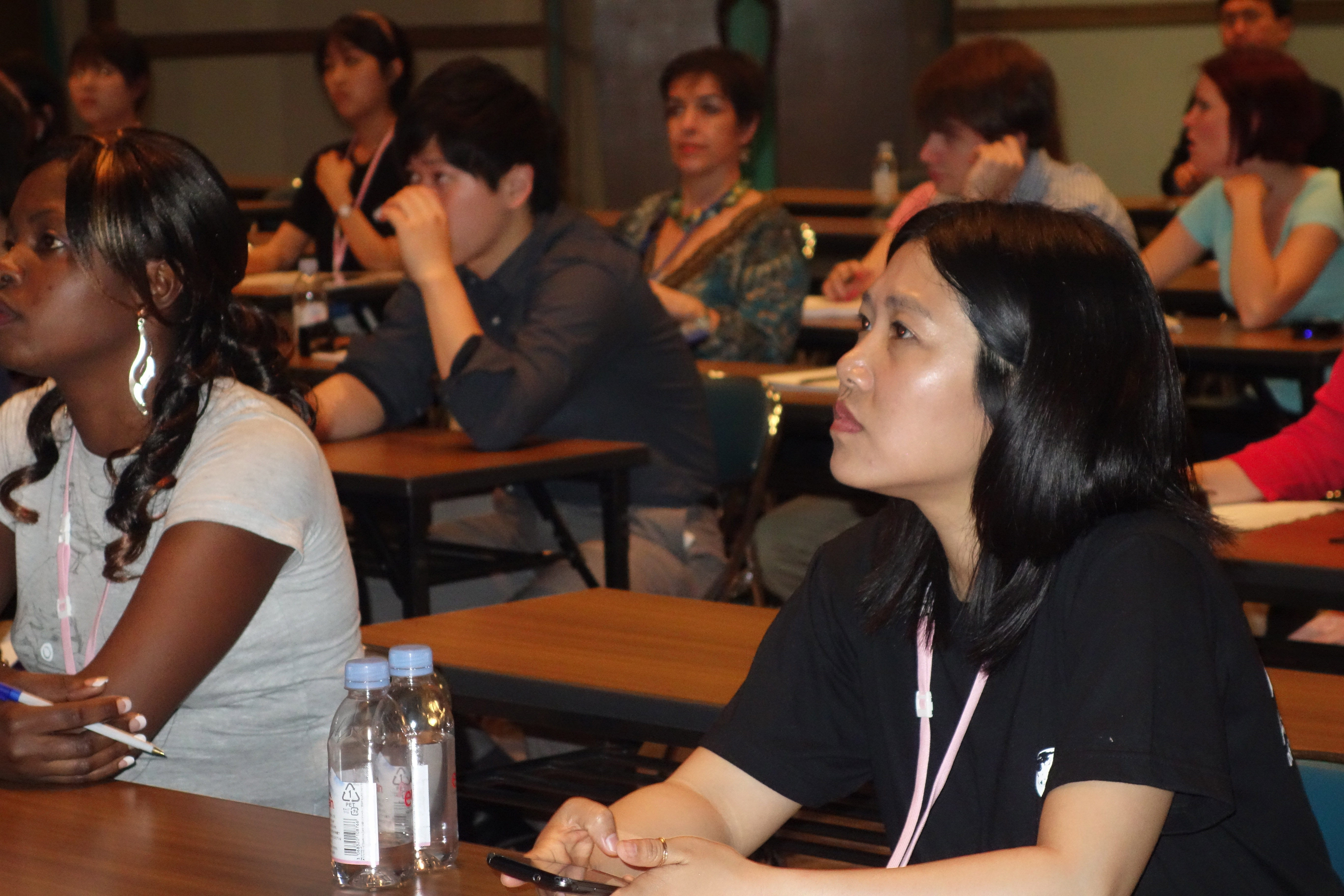 Esther Ojong Ntui of Cameroon, a student at Africa University, and Daphy Nataloo, Myanmar, Yonsei University, listen to a presentation by Courtney Lawrence, who teaches global studies at Hiroshima Jogakuin University. Photo by Diane Degnan, United Methodist Communications.