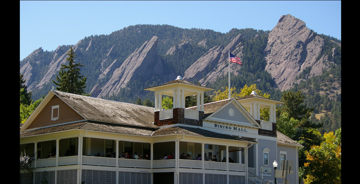 The dining hall in Chautaqua Park in Boulder, Colorado, with the Flatirons rock formations behind it. Photo by Hustvedt, Wikimedia Commons. Taken 2008.