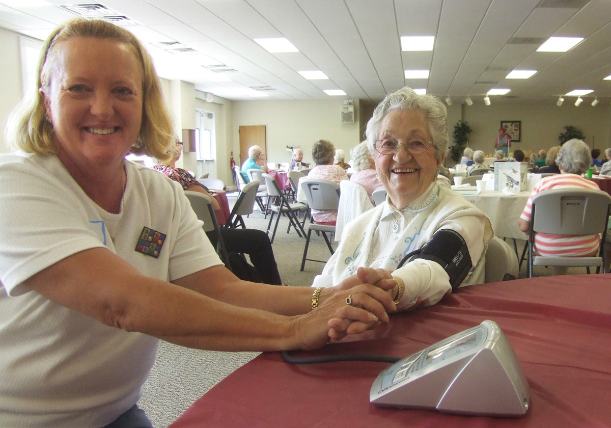 A nurse volunteer takes blood  pressures during a WelcomeTable event organized by Givens LifeMinistries at Mills River near Asheville, N.C.
Photo courtesy Shelia Mlz. 