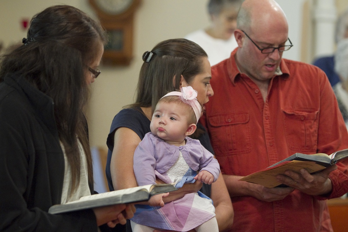 New life brings new hope at rural churches. Avery Guest, 6 months, keeps a watchful eye on Kati Thain during worship at Gilboa (Ohio) United Methodist Church. Photo by Mike DuBose, UMNS.
