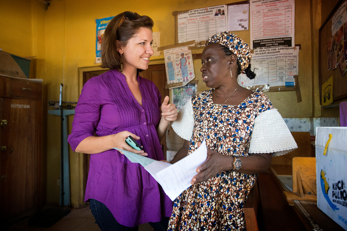 Maeghan Orton (left) learns about how medical records are kept at the United Methodist Church's Mercy Hospital in Bo Sierra Leone, from Taiwo Sesay, who oversees the hospital's maternity unit.