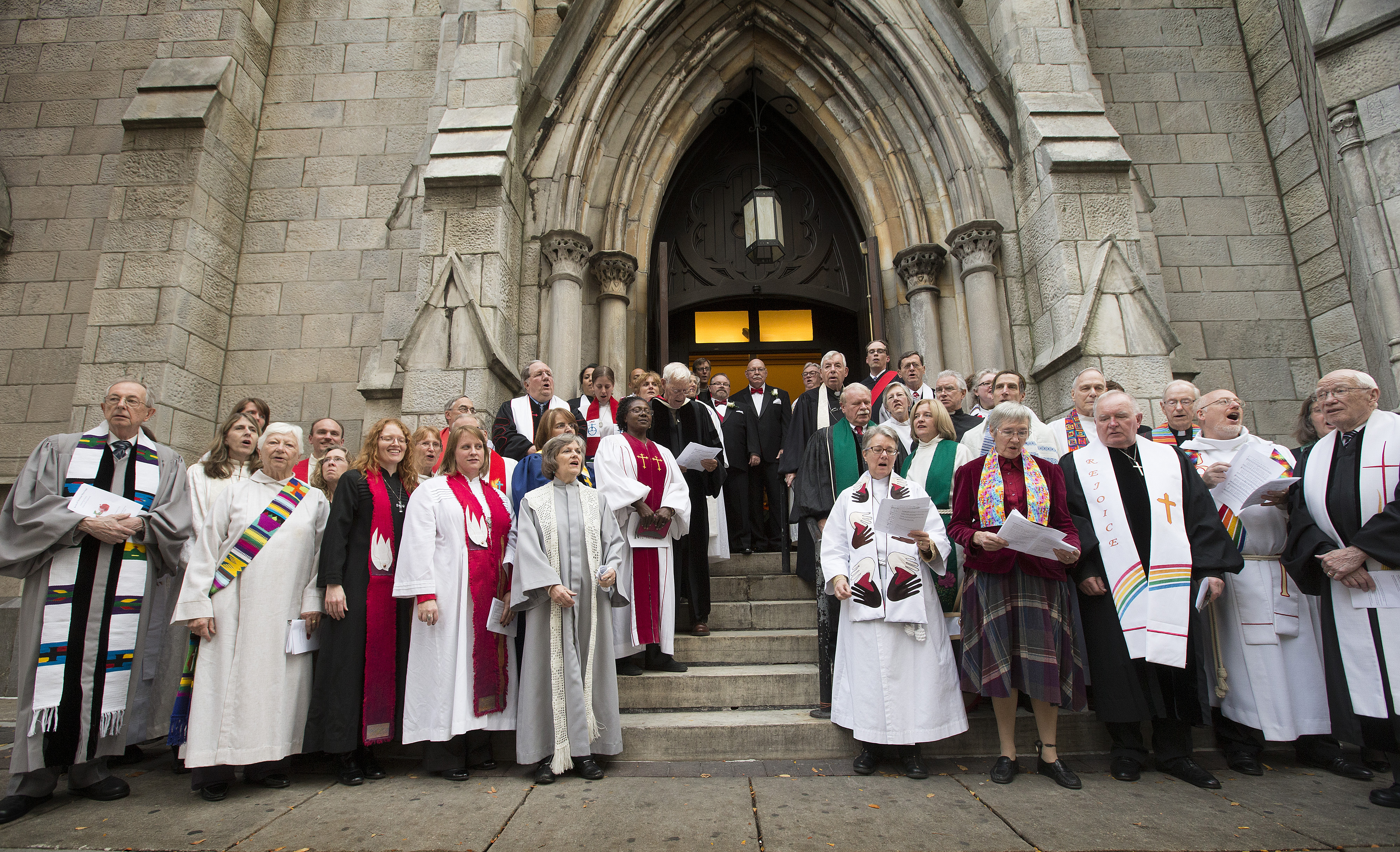 Clergy and faith leaders gather outside Arch Street United Methodist Church in Philadelphia in support of  Richard Taylor and William Gatewood (at top of stairs in doorway) following their Nov. 9, 2013 wedding