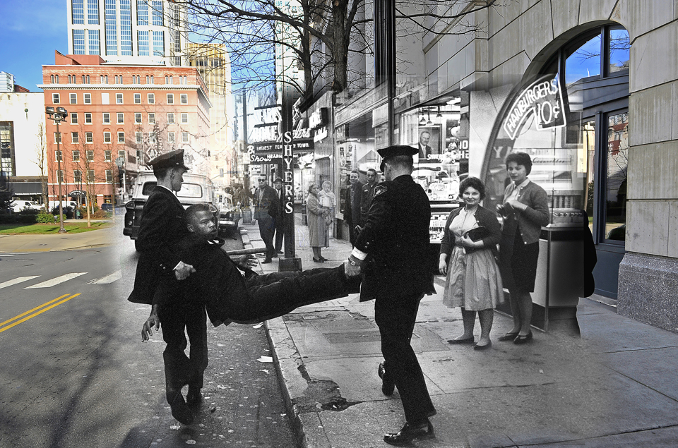Civil Rights leader, John Robert Lewis, is carried to a waiting police paddy wagon following his arrest after Lewis and two others failed to obey police orders to move away from a restaurant's entrance on Church Street. 