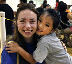 Writer, Kelly Caviness, and Dee Da, at Project Transformation's Family Fun Night. Photo by Kathleen Barry, United Methodist Communications