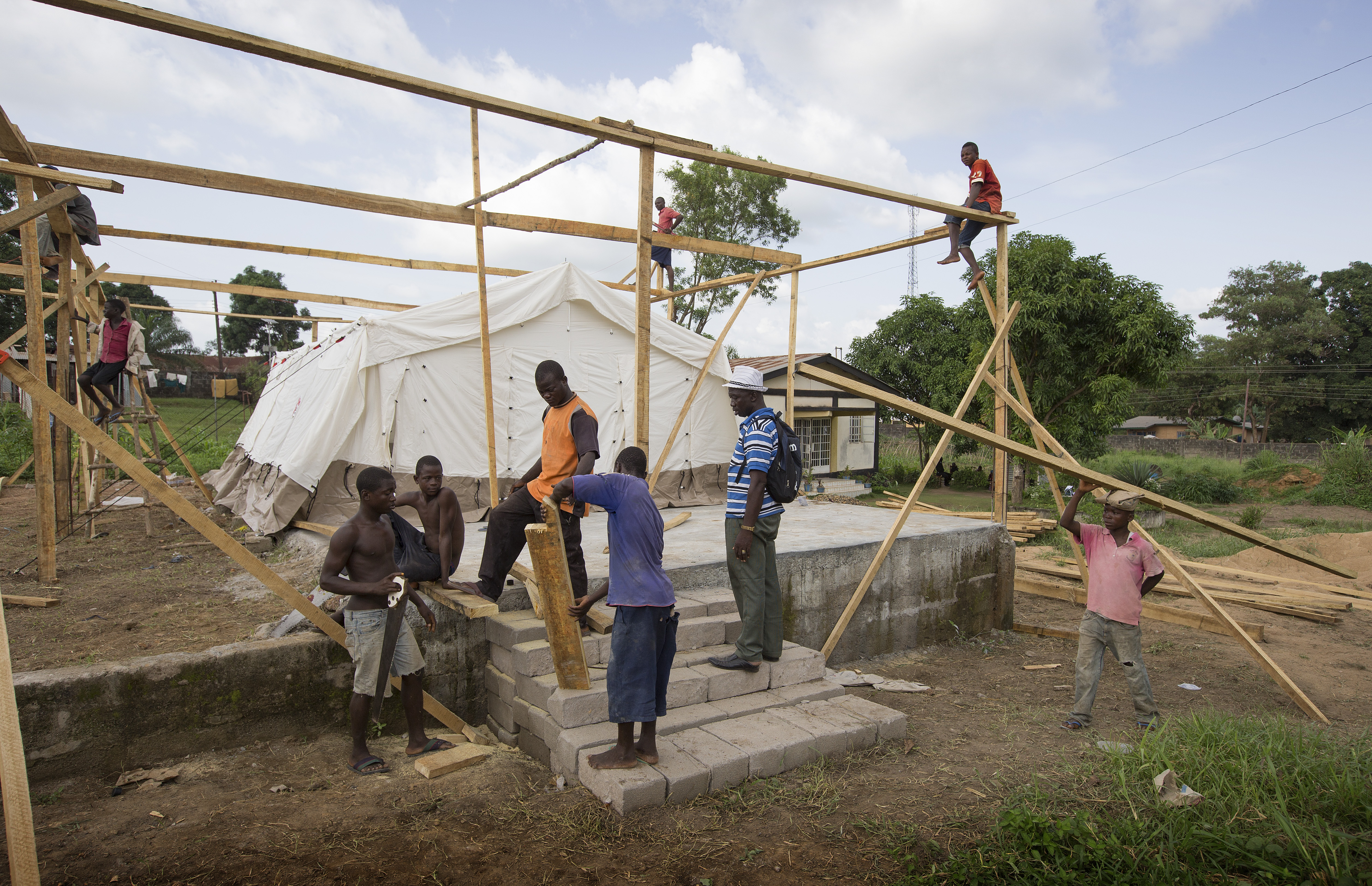 Workers erect a temporary isolation ward for patients with the Ebola virus at the government hospital in Kenema, Sierra Leone. 