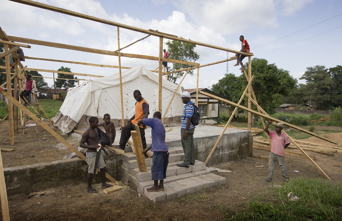 Workers erect a temporary isolation ward for patients with the Ebola virus at the government hospital in Kenema, Sierra Leone. 