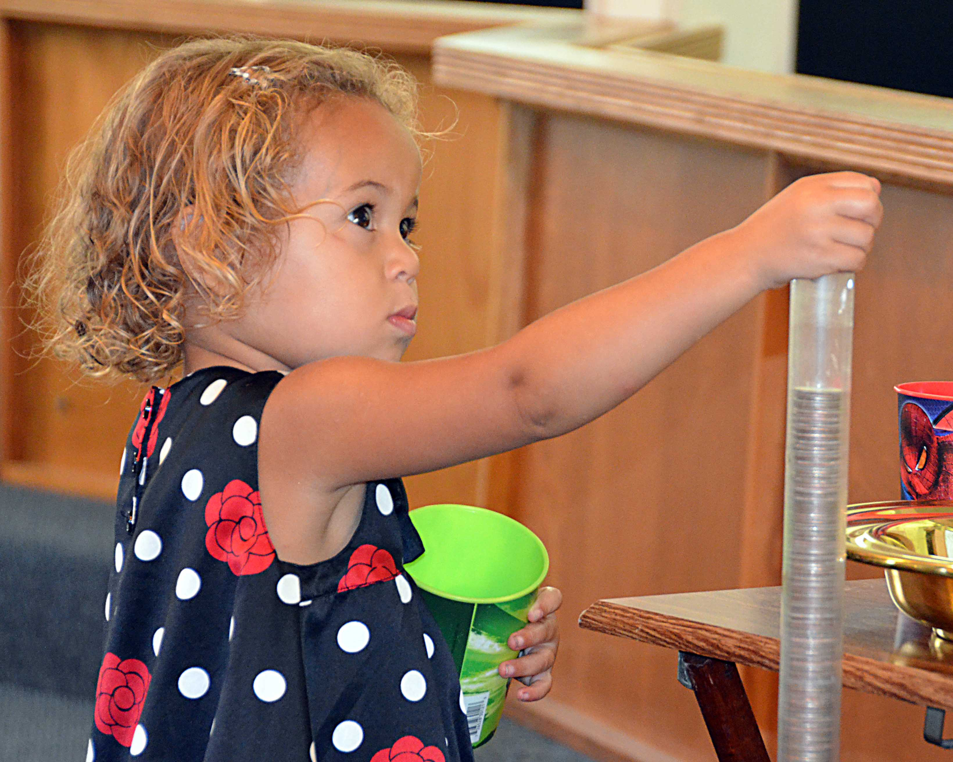 Alaia Williams put puts quarter in the tube for Imagine No Malaria campaign at Aley United Methodist Church in Seven Points, Texas. Photo by Richard Browne.