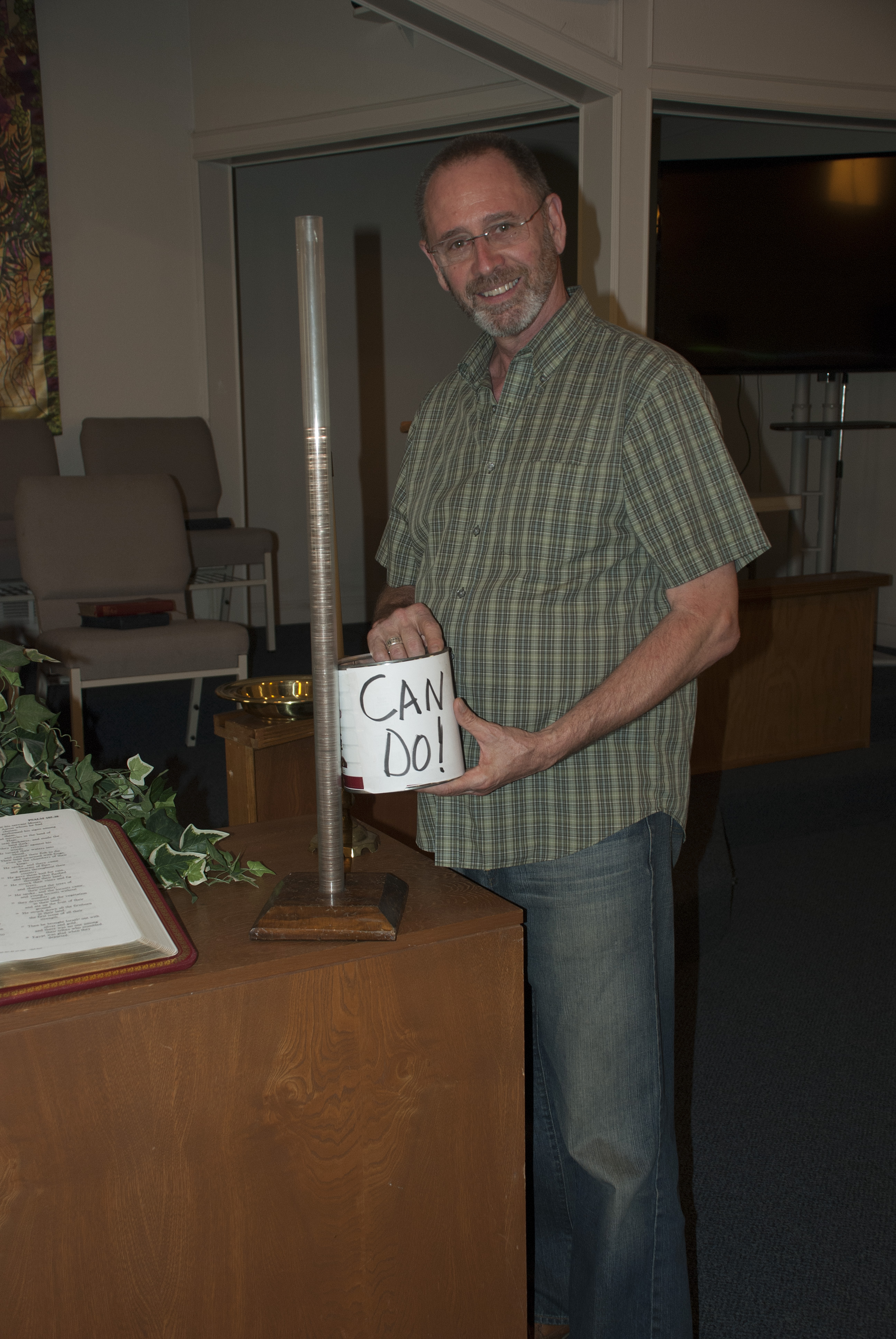 The Rev. Eston Williams of Aley United Methodist Church in Seven Points, Texas, with I Can Do! Can for Imagine No Malaria. Photo by Joan La Barr.