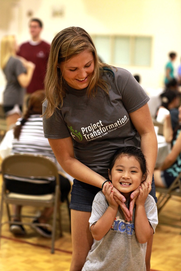 First year intern, Sarah Fuquay, shares a moment with a little girl at the Family Fun Night.  Fuquay is a sophomore at Butler University.