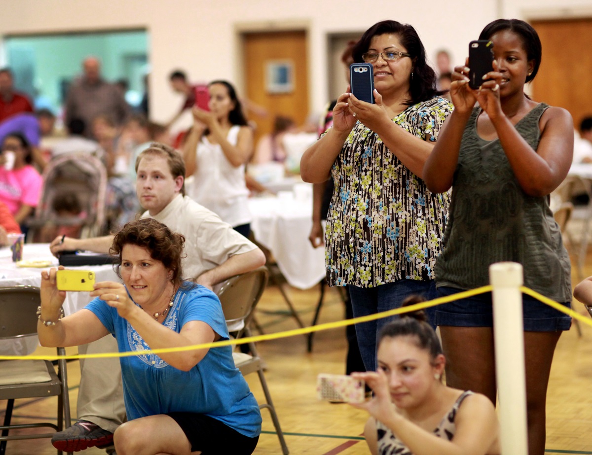 Here the “family” members of Family Fun Night document the action with their smart phones. Project Transformation impacts the community as well as the interns and children. 