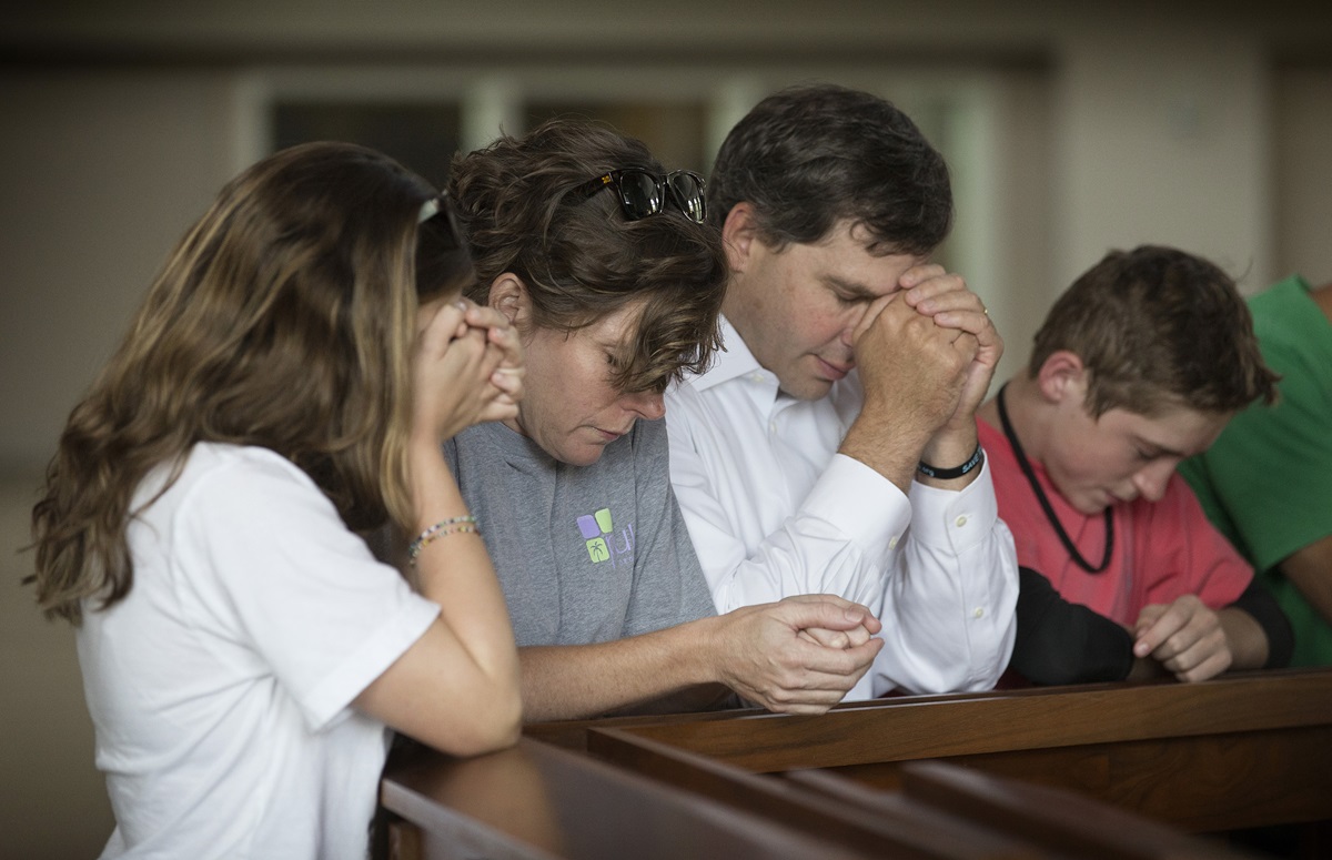 Members of the Bonn family pray during a service at Christ United Methodist Church in Franklin, Tenn., to lift up those facing the Ebola crisis in West Africa. From left are: Ashley, Debbie, Danny and Miles. 