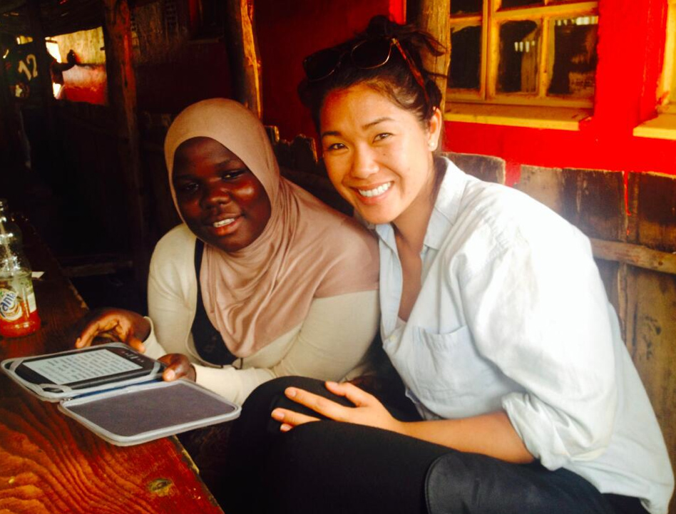 Worldreader partnership development manager Kristina Lee looks at an e-reader with a student in Kenya. Photo courtesy of Kristina Lee.